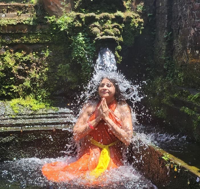 Spiritual purification ritual with flowing water in a lush natural setting